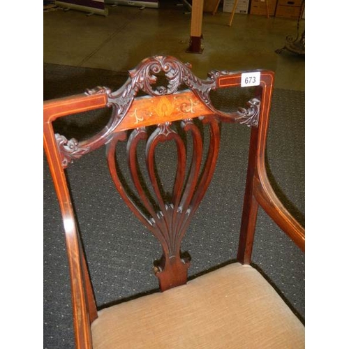 673 - An Edwardian inlaid elbow chair.