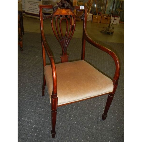 673 - An Edwardian inlaid elbow chair.