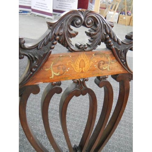 673 - An Edwardian inlaid elbow chair.