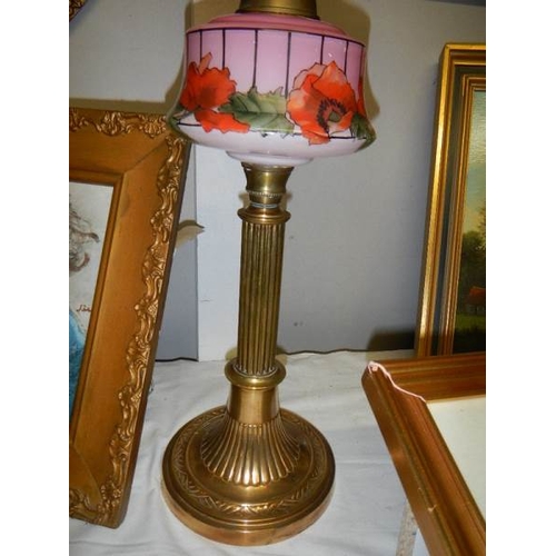 678 - A Brass column oil lamp with floral pink font and acid etched shade.