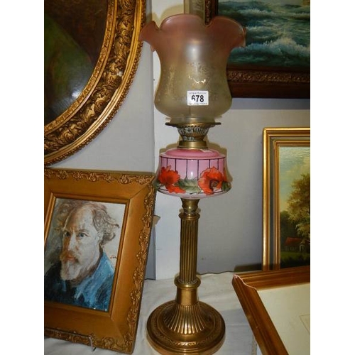 678 - A Brass column oil lamp with floral pink font and acid etched shade.