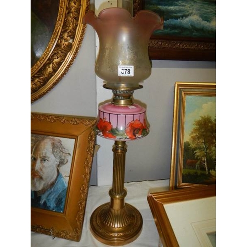 678 - A Brass column oil lamp with floral pink font and acid etched shade.