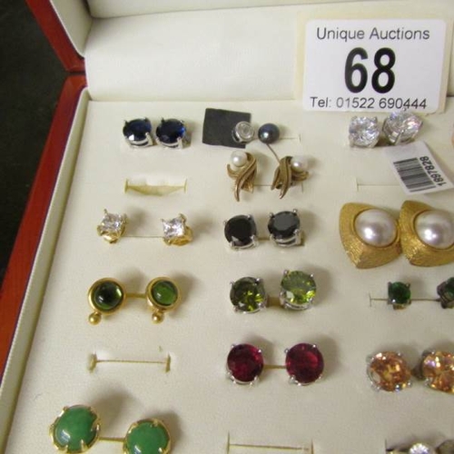 68 - A case containing approximately 34 pairs of earrings including turquoise and pearl.