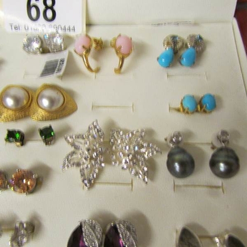 68 - A case containing approximately 34 pairs of earrings including turquoise and pearl.