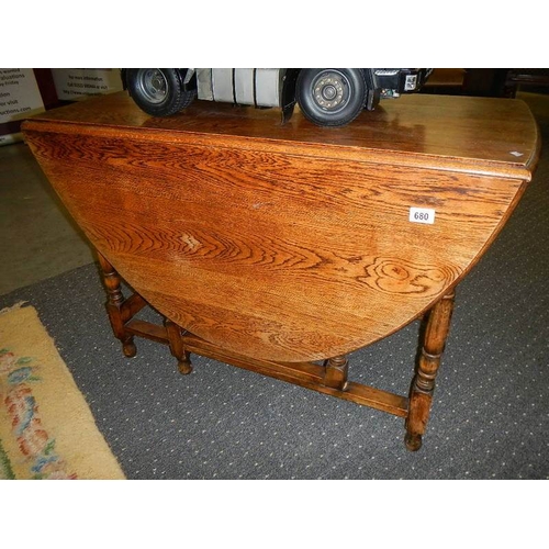 680 - A good quality oak drop leaf dining table.