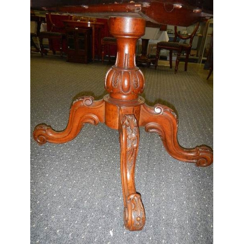 681 - A Victorian mahogany tip top dining table.