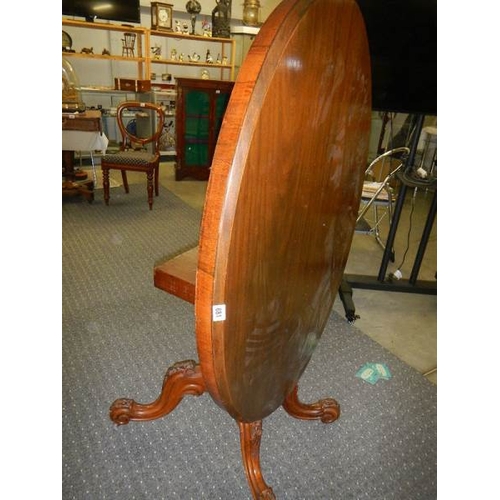 681 - A Victorian mahogany tip top dining table.