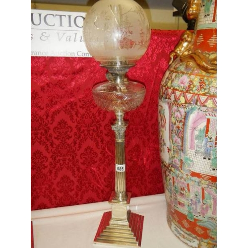 685 - A silver plated Elkington column oil lamp with cut glass font.