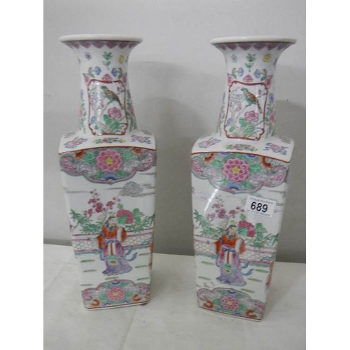 689 - A pair of square based Chinese vases, 42 cm tall.