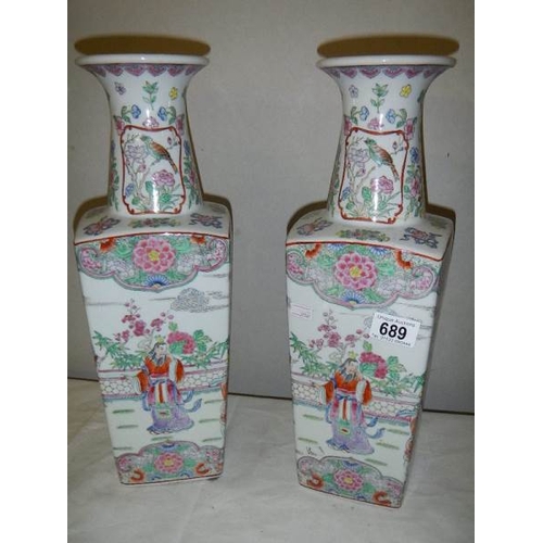 689 - A pair of square based Chinese vases, 42 cm tall.