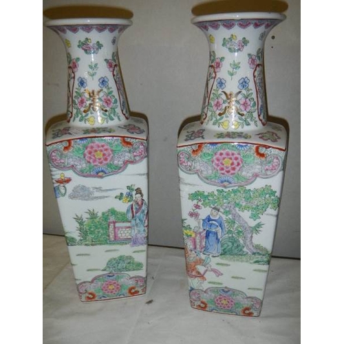 689 - A pair of square based Chinese vases, 42 cm tall.