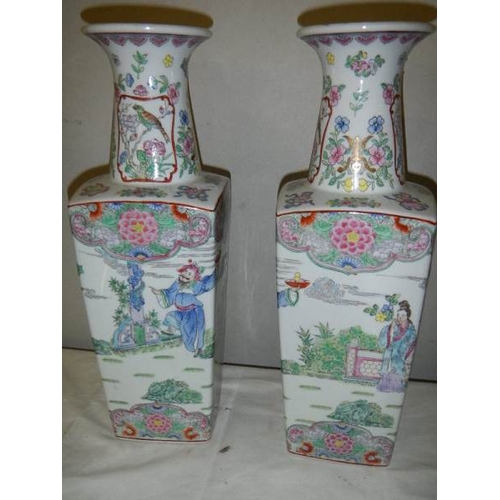 689 - A pair of square based Chinese vases, 42 cm tall.