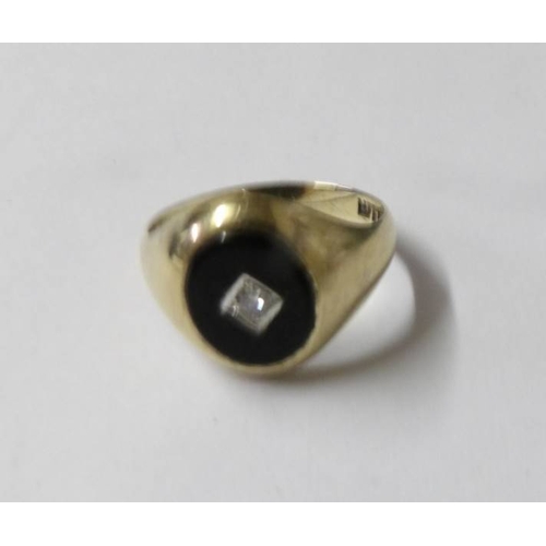 82 - A 9ct yellow gold black onyx surrounded by 20pt diamonds ring, size R.