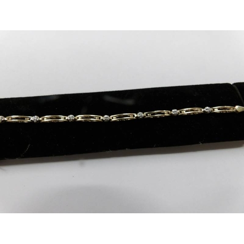 86 - A 10ct yellow gold and diamond bracelet.