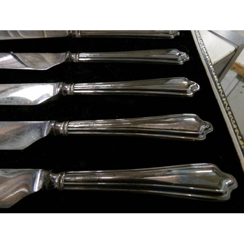 99 - A cased set of 6 silver handled knives.