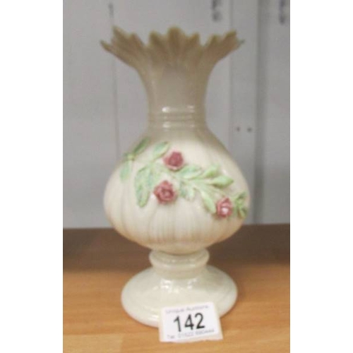 142 - A belleek vase with applied rose decoration, 20 cm tall.