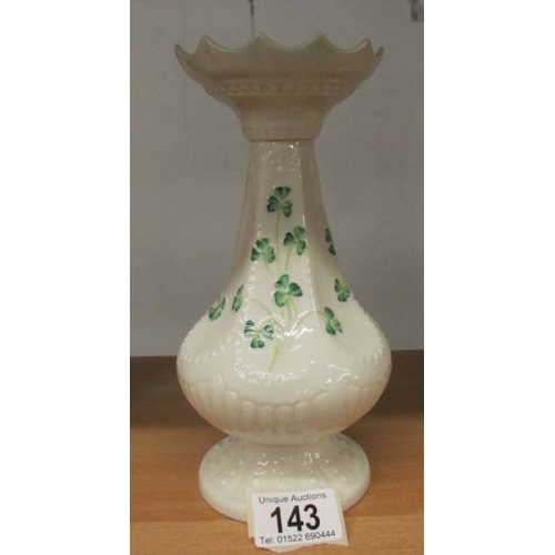 143 - A Belleek vase decorated with shamrocks, 20 cm tall.