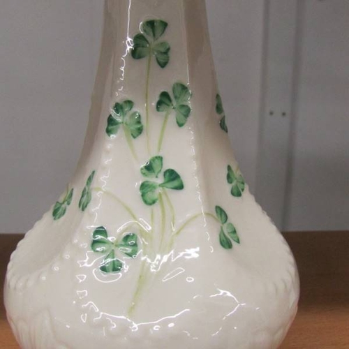 143 - A Belleek vase decorated with shamrocks, 20 cm tall.