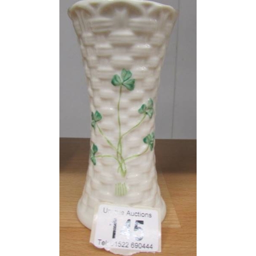 145 - A Belleek vase decorated with shamrocks, 14 cm tall.