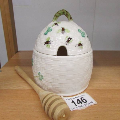 146 - A Belleek honey pot decorated with shamrocks and bees.