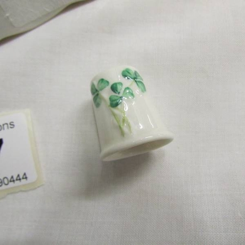 147 - A Belleek pin tray and thimble decorated with shamrocks.