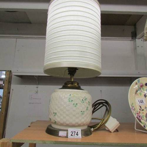 274 - A Belleek table lamp with shade.