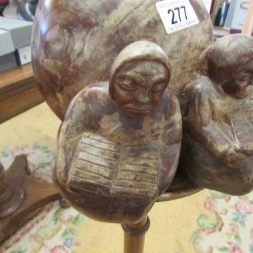 277 - A wood carving with two Inuit figures.