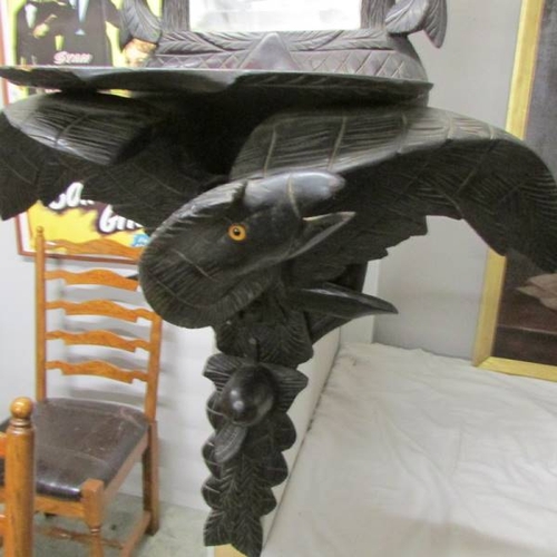 279 - A Black Forest carved wall/hall mirror surmounted 2 eagles with glass eyes. (155 cm / 61'' tall).