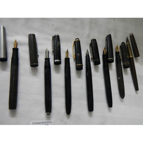 297 - A good collection of fountain pens (4 with gold nibs) and a quantity of ball point pens.