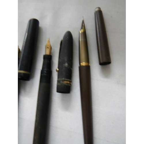 297 - A good collection of fountain pens (4 with gold nibs) and a quantity of ball point pens.