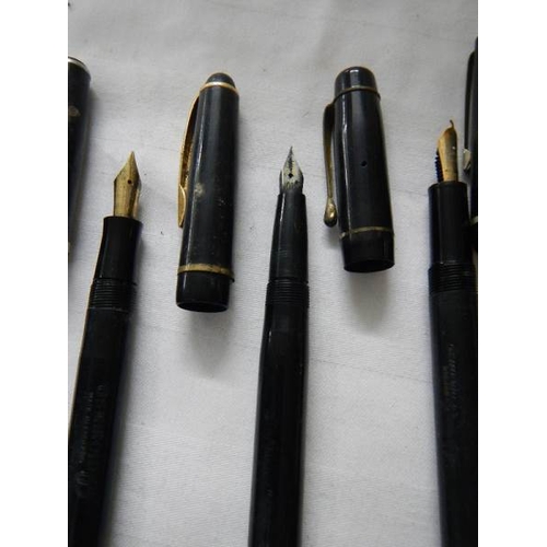 297 - A good collection of fountain pens (4 with gold nibs) and a quantity of ball point pens.