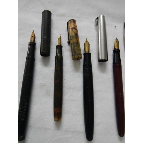 297 - A good collection of fountain pens (4 with gold nibs) and a quantity of ball point pens.