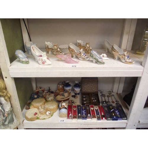 373 - 2 shelves of collectors shoes, spoons, 2 items of Pendelfin etc.