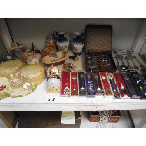 373 - 2 shelves of collectors shoes, spoons, 2 items of Pendelfin etc.