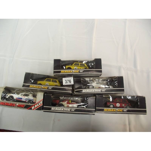 376 - 6 boxed Scalextric cars including Mini TR7 etc. In used condition, boxes a/f