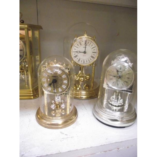 377 - 6 clocks including anniversary clocks under plastic domes