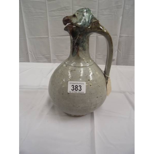 383 - An unusual stoneware jug with handle. A birds head forms the lid and spout. No makers marks observed... 