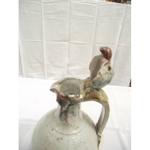 383 - An unusual stoneware jug with handle. A birds head forms the lid and spout. No makers marks observed... 