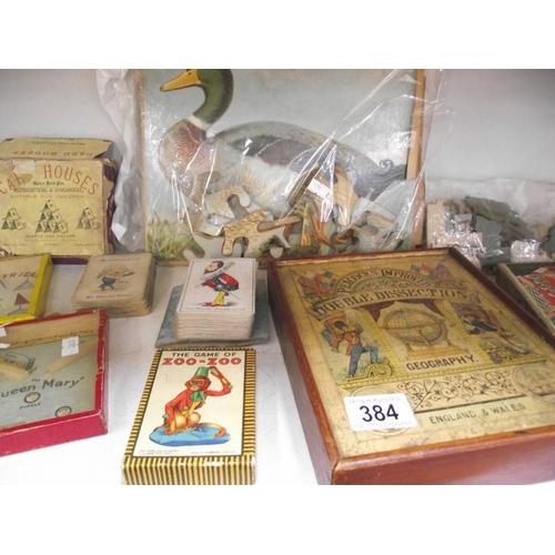 384 - A shelf of vintage puzzles, games, jigsaws, cards etc. (completeness of jigsaws unknown)