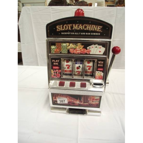 387 - A vintage toy slot machine 1 arm bandit, battery operated. Height 38cm at highest point.