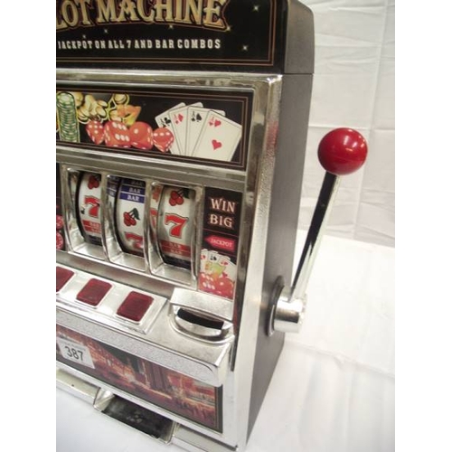 387 - A vintage toy slot machine 1 arm bandit, battery operated. Height 38cm at highest point.