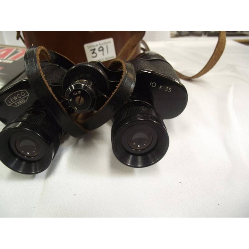 391 - A pair of binoculars Lewco, Paris 10 x 35 and an In Combat folder