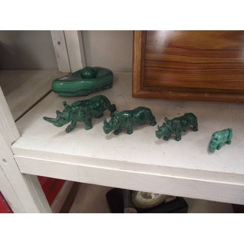 394 - A collection of green malacite animals etc. and a wooden tray