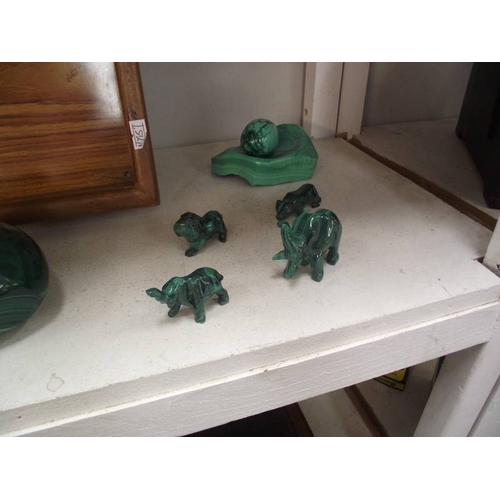 394 - A collection of green malacite animals etc. and a wooden tray