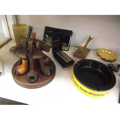 404 - A good collection of smoking and tobacco related items including 2 pipe racks, pipes, advertising wa... 