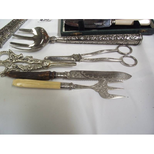 430 - A cased set of butter knives, salad servers, serving spoons, grape scissors etc.