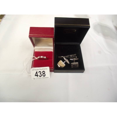 438 - A 9ct gold ring set stones 2.7g size V and a pair of silver cufflinks and matching tiepin