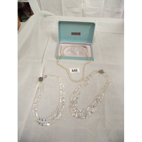 440 - 2 crystal necklaces and a pearl necklace