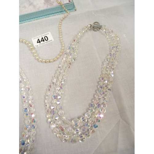 440 - 2 crystal necklaces and a pearl necklace