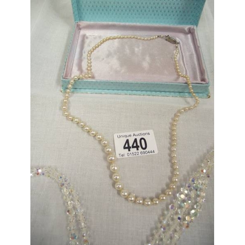 440 - 2 crystal necklaces and a pearl necklace